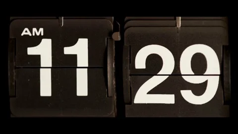 Retro mechanical flip clock changes from eleven twenty nine Stock Footage 329673860