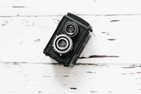 Retro medium format camera on wood table background, vintage concept, text sp Stock Photos