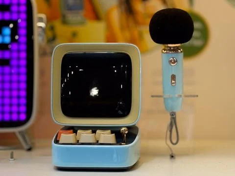 Retro microphone and screen display in modern retail space. Technology, commu Stock Photos
