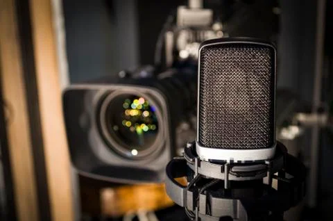 Retro microphone on stage a background of studio camera Stock Photos