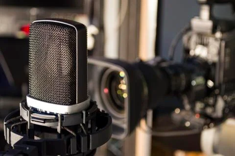 Retro microphone on stage a background of studio camera Stock Photos