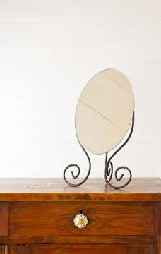 Retro mirror on bedside table,  background white wooden wall Stock Photos