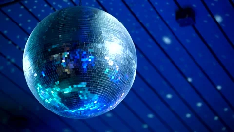 A retro mirror disco ball covered in webbing spins in a closed club Video stock 285843327