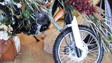 Retro motorcycle stands with flowers Stock Footage 60924360