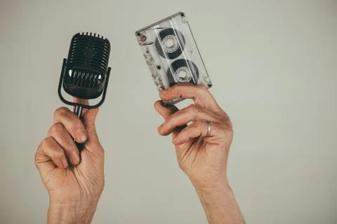 Retro music, cassette and microphone in hands of old woman, retro sound Stock Photos