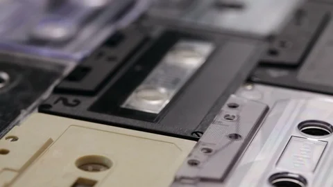 Retro music compact cassettes on a table, shallow depth - camera sliding Video stock 88672106