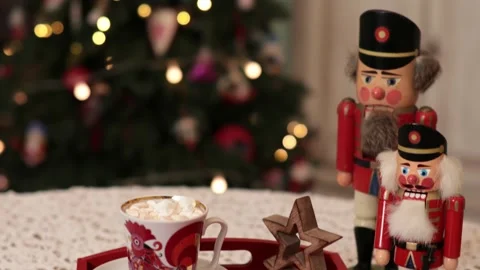 Retro nutcrackers and cup of marshmallow cacao on red tray with Christmas lights Video stock 167474971