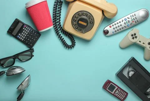 Retro objects on blue background. Rotary telephone, audio cassette, video cas Stock Photos