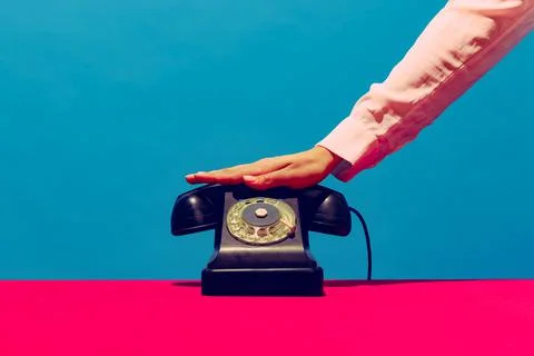 Retro objects, gadgets. Female hand holding handset of vintage phone isolated on Stock Photos