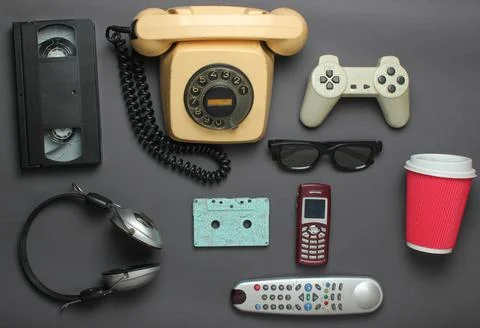 Retro objects on gray background. Rotary telephone, audio cassette, video cas Stock Photos