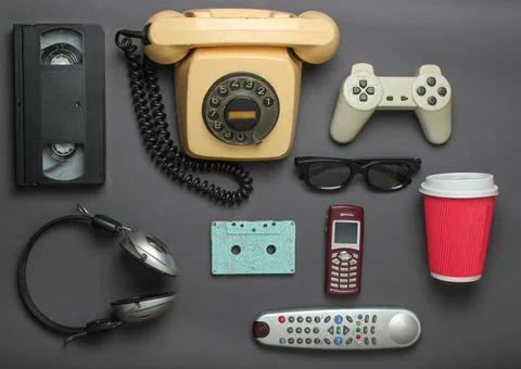 Retro objects on gray background. Rotary telephone, audio cassette, video cas Stock Photos