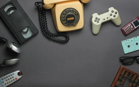 Retro objects on gray background. Rotary telephone, audio cassette, video cas Stock Photos