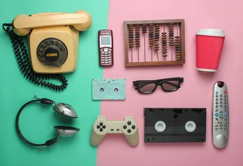 Retro objects on pastel background. Rotary telephone, audio cassette, video c Stock Photos