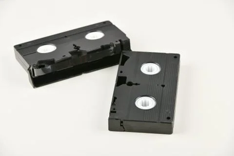 Retro objects on a white background. push-button telephone and video cassette Stock Photos