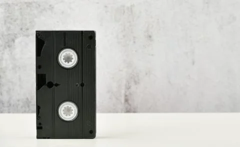 Retro objects on a white background. push-button telephone and video cassette Stock Photos