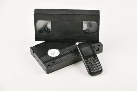Retro objects on a white background. push-button telephone and video cassette Stock Photos