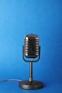 Retro old style microphone on color background Stock Photos