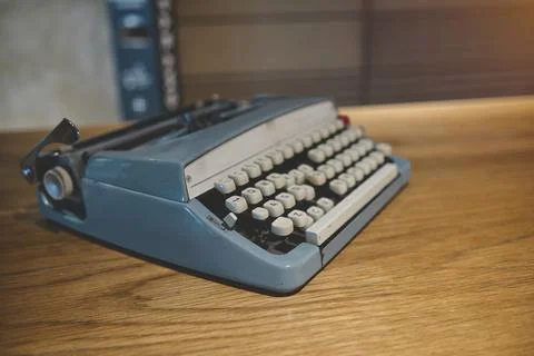 Retro old typewriter on blur background and front of wooden table. Vintage Stock Photos