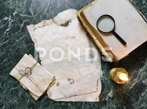 Retro papers and book on detective work table with tools Stock Photos