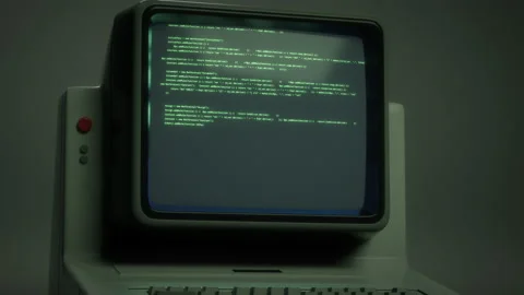 Retro personal computer or PC with source code displayed on monitor Stock Footage 147950973