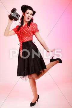 Retro. Pinup girl taking photo with vintage camera Stock Photos