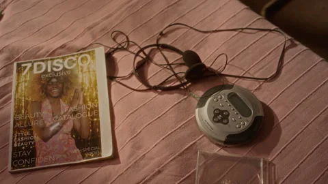 Retro Portable Cd Player with Headphones Lying on Bed in Bedroom Stock Footage 343629370