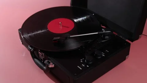 Retro portable record player with vinyl disc spinning and needle in place Stock Footage 339001453