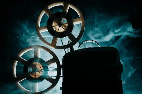 Retro projector playing motion picture. dark room. Timeless flicker of old .. Fotos de archivo