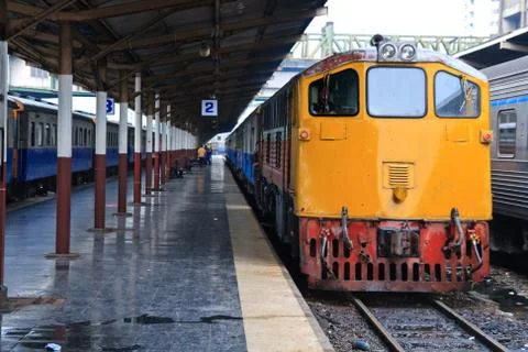 Retro red orange train, deisel locomotive, on bangkok railway station platfor Stock Photos