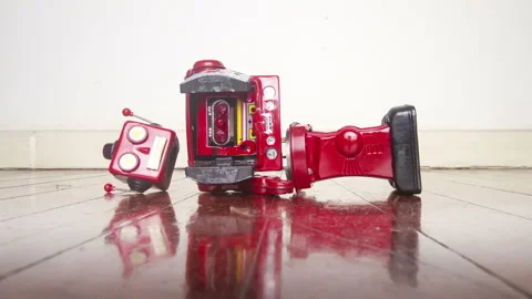 A retro red robot is broken on an old wooden floor Stock Footage 149230401