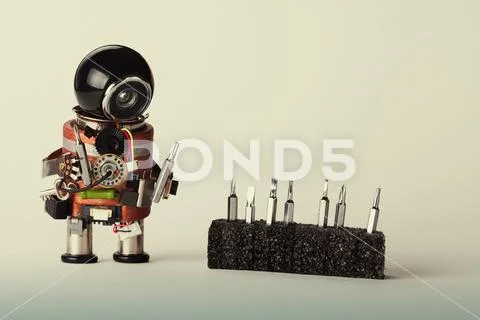 Retro robot with screwdriver set. Fun toy repair man character, black helmet Stock Photos
