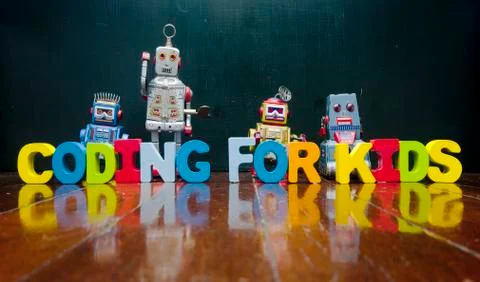 Retro robots and the words CODING FOR KIDS Stock Photos