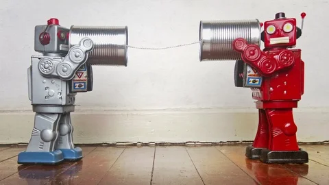 Retro robots on old tin can phones 스톡 동영상 127437602