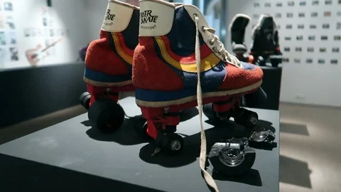 Retro roller skates are on display among other items at a 90's museum Stock Footage 98468869