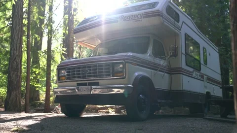 Retro RV motorhome parked in forest campsite (Part 1) Wide shot. Video stock 218275853