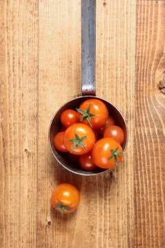 Retro saucepan full of tomatoes Stock Photos