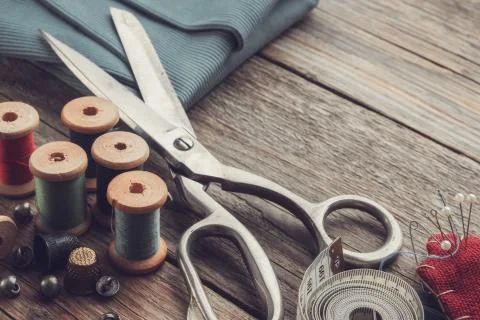 Retro sewing items: scissors, cutting knife, thimble, threads, pin cushion Stock Photos