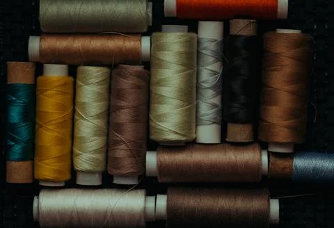 Retro sewing items: tailoring scissors, cutting knife, thimble, wooden thread Stock Photos