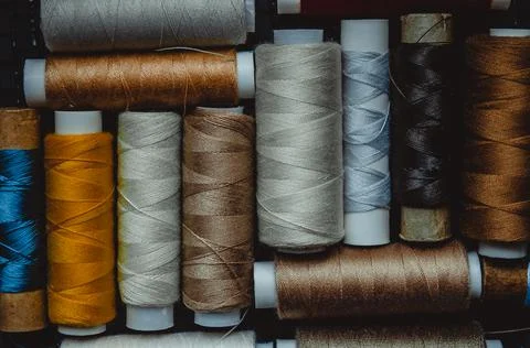 Retro sewing items: tailoring scissors, cutting knife, thimble, wooden thread Stock Photos