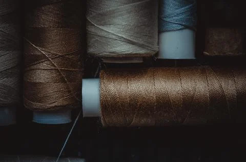 Retro sewing items: tailoring scissors, cutting knife, thimble, wooden thread Stock Photos