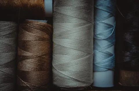 Retro sewing items: tailoring scissors, cutting knife, thimble, wooden thread Stock Photos