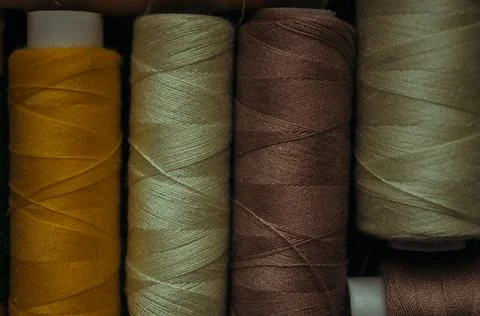 Retro sewing items: tailoring scissors, cutting knife, thimble, wooden thread Stock Photos