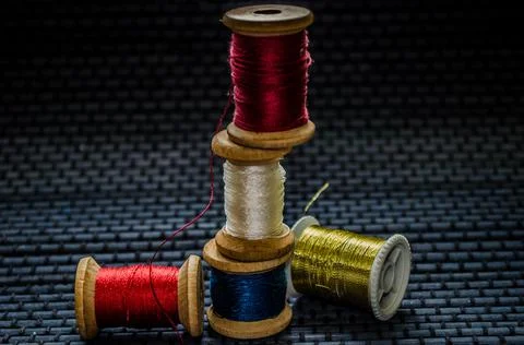 Retro sewing items: tailoring scissors, cutting knife, thimble, wooden thread Stock Photos