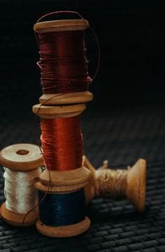 Retro sewing items: tailoring scissors, cutting knife, thimble, wooden thread Stock Photos