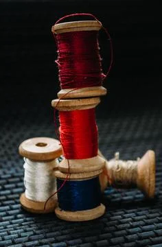Retro sewing items: tailoring scissors, cutting knife, thimble, wooden thread Stock Photos
