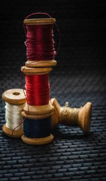 Retro sewing items: tailoring scissors, cutting knife, thimble, wooden thread Stock Photos