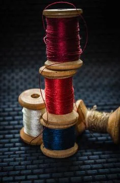 Retro sewing items: tailoring scissors, cutting knife, thimble, wooden thread Stock Photos