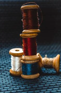 Retro sewing items: tailoring scissors, cutting knife, thimble, wooden thread Stock Photos