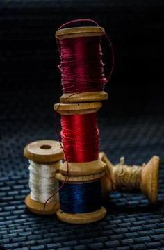 Retro sewing items: tailoring scissors, cutting knife, thimble, wooden thread Stock Photos