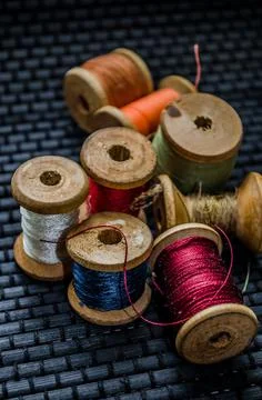 Retro sewing items: tailoring scissors, cutting knife, thimble, wooden thread Stock Photos